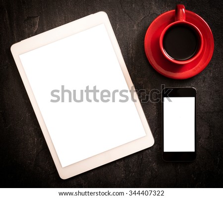Tablet and smart phone with blank screens on dark background 