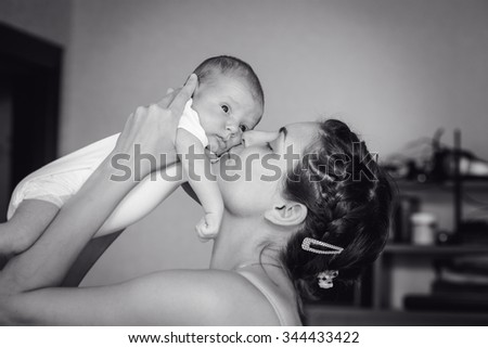 happy mother with newborn baby, black and white