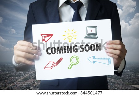 businessman show coming soon text on paper , business concept , business idea