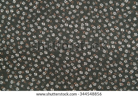 Pattern roses on black cloth fabric.
