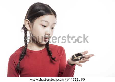 A asian(korean, japanese, chinese) girl(woman, female) make a pose with smile and hold a compass to study(work) isolated white.