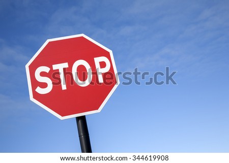 Red Stop Traffic Sign on Blue Sky Background
