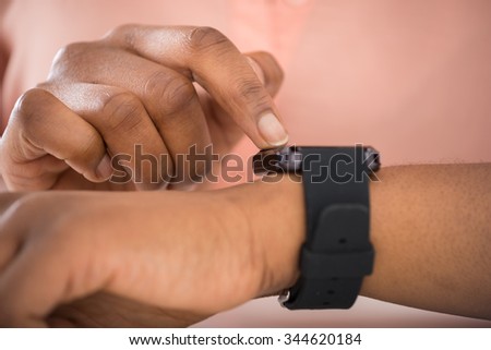 Close-up Photo Of African Person Using Smartwatch Royalty-Free Stock Photo #344620184