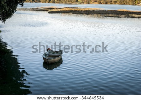 Barque, Small wood boat on the water by sunset