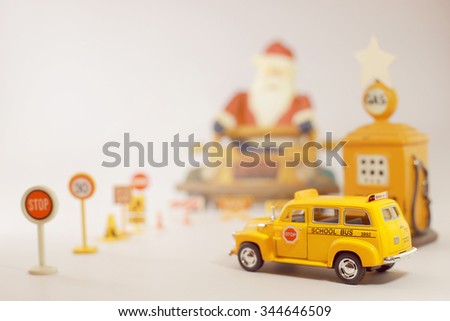 Yellow school bus toy model in Christmas theme.Selective focus and very shallow depth of field composition.Christmas wallpaper in Vintage style.