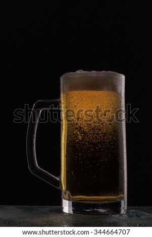 glass of beer on a black background