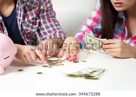 Happy couple counting money from the moneybox
