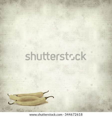 textured old paper background with yellow chilli pepper