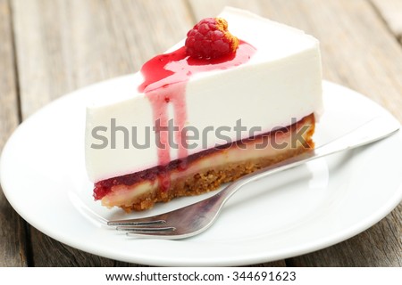 Fresh raspberry cheesecake on white plate