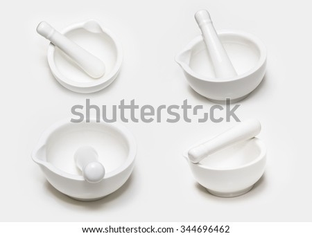 Set of four white ceramic mortar and pestle isolated on white background