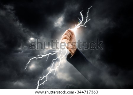 business woman hand clenching lightning flash
