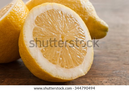 closeup of yellow lemon on wooden background