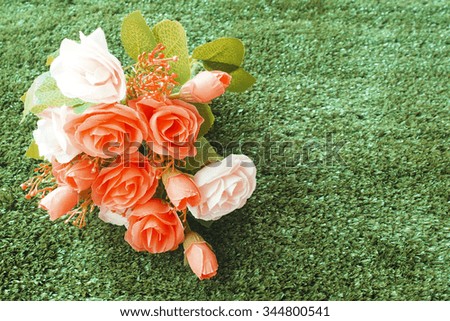 Colorful vintage flower on artificial grass field background
