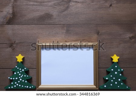 One Golden Picture Frame With Two Green Christmas Tree. Copy Space For Advertisement. Christmas Card For Seasons Greetings. Christmas Decoration With Brown Wooden And Rustic Retro Background.