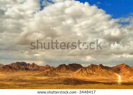  The sun and clouds above mountains of desert Sinai