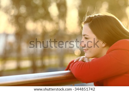 Pensive relaxed girl thinking in winter looking forward at sunset Royalty-Free Stock Photo #344851742