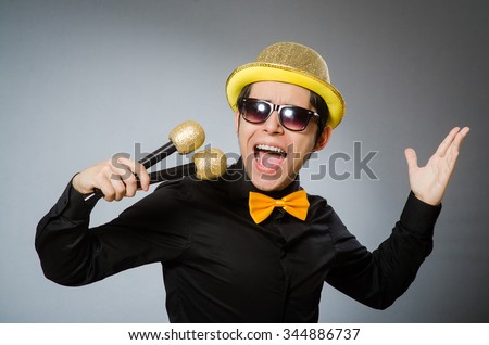 Funny man with mic in karaoke concept