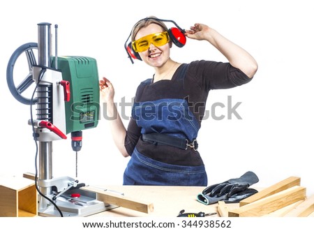 beautiful female carpenter at work using vertical drilling machine. Photo on white background.