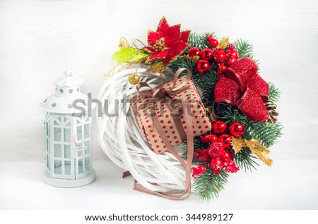 Christmas wreath with a  lantern and a gift box before the holiday.