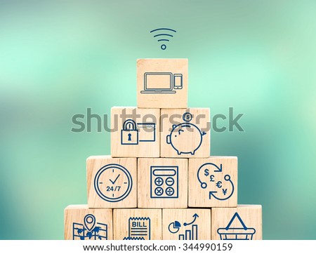 Mobile banking feature icon on wood cube pyramid with blur blur background, Digital marketing concept.