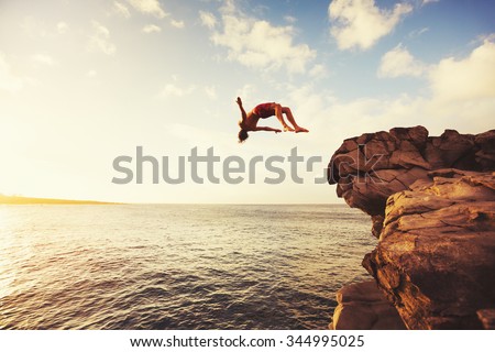 Cliff Jumping into the Ocean at Sunset, Summer Fun Lifestyle Royalty-Free Stock Photo #344995025