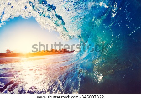 Blue Ocean Wave Crashing at Sunrise Royalty-Free Stock Photo #345007322