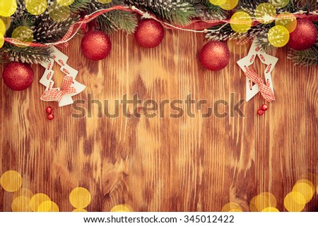 Christmas tree branch with decorations on wood background. Xmas holiday concept