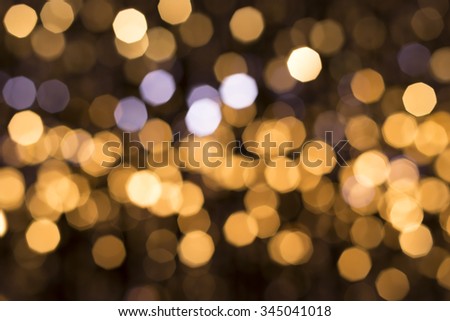 Abstract glittering lights, gold background, a real photo in the blur
