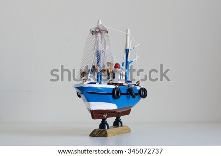 Blue toy boat with white background at angle