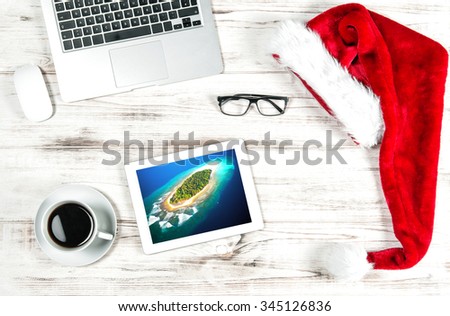 Office Workplace with Cup of Coffee and travel picture. Business Holidays Concept
