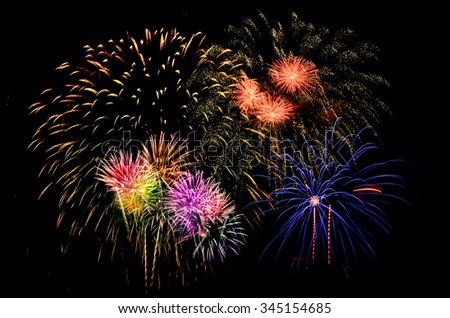 Colorful firework celebration on dark background.