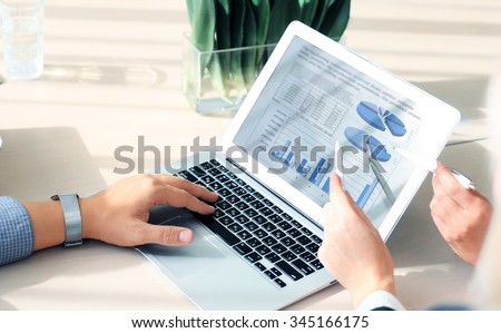 Business adviser analyzing financial figures denoting the progress in the work of the company Royalty-Free Stock Photo #345166175