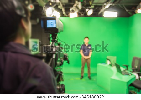 blur image A television presenter in a TV camera in studio a green Royalty-Free Stock Photo #345180029