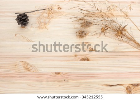 Wooden background with dry wild flowers