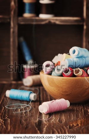 Color threads on the vintage table, selective focus
