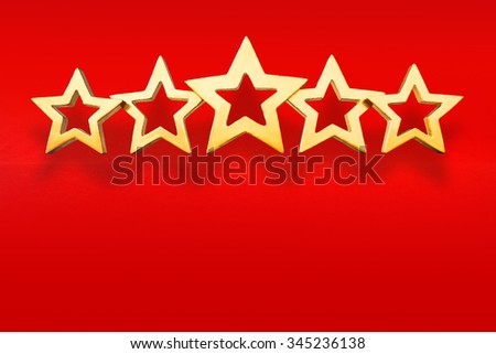 Five golden shimmering stars on red background, symbol for the winner of a competion, copy or text space