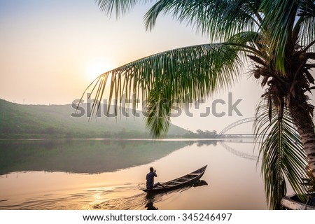 Paddling in traditional wooden canoe, Ghana, Africa Royalty-Free Stock Photo #345246497