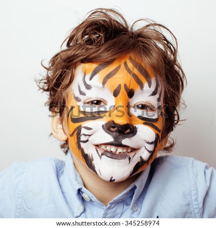 little cute boy with faceart on birthday party close up, little cute orange tiger