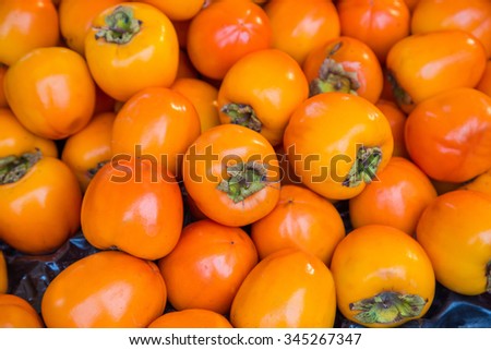 Orange persimmon kaki fruits freshly Royalty-Free Stock Photo #345267347