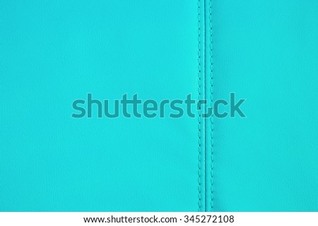 Background full frame texture of Light Blue artificial leather with a stitched seam on an upholstered settee or couch in an interior decorating concept.