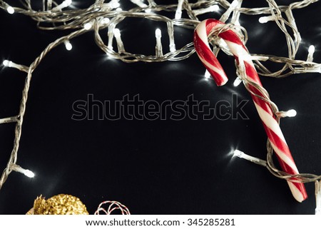 amazing beautiful  christmas silver vintage garland lights and candy on stylish black background
