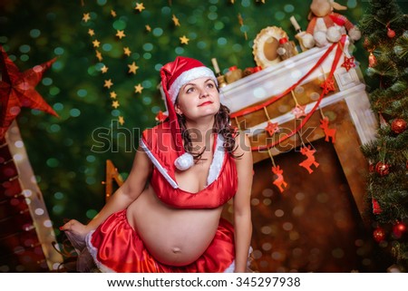 christmas holiday pregnant woman in santa hat 