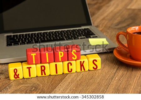 Tips & Tricks written on a wooden cube in a office desk