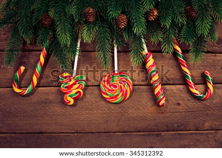 Merry Christmas. Christmas ornaments on wood with candy. Studio shot