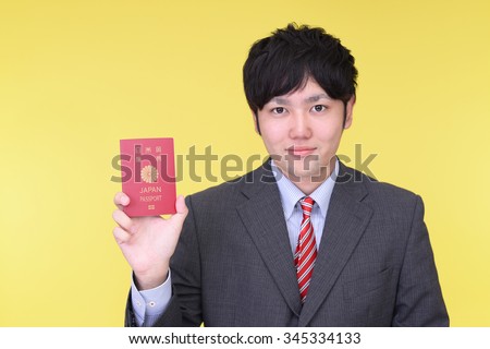 Smiling Asian man with a passport