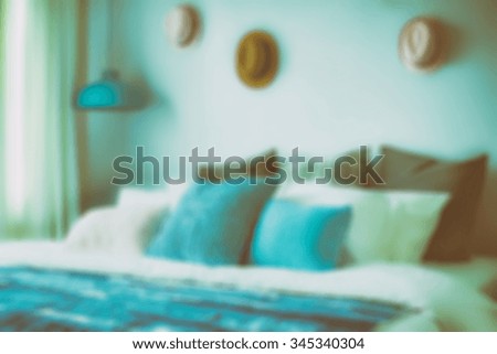 blur image of blue color scheme teenager bedroom with hats on wall decoration