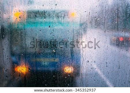 Drops Of Rain On Glass On Glass Background. Abstract Street Colorful background