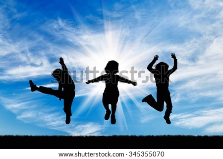 Concept of happiness. Silhouette happy children jumping against the beautiful sky