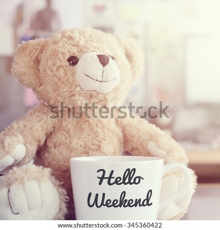 Hello Weekend coffee cup,focused on teddy bear face in Blurred background with vintage filter Royalty-Free Stock Photo #345360422