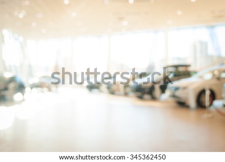 Blurred dealership store, with the cars and soft lightning Royalty-Free Stock Photo #345362450
